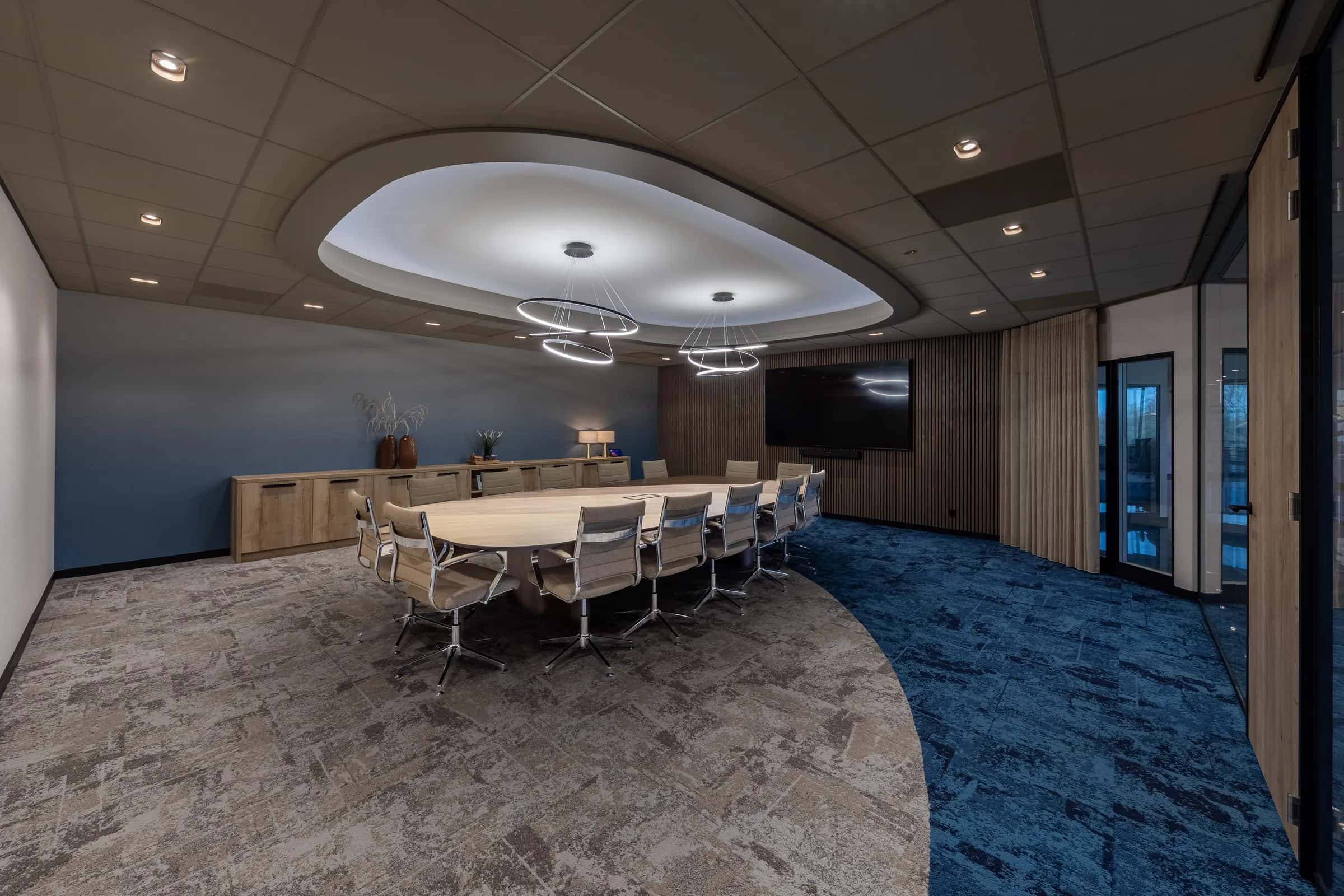 Wide view of the Kramer Seafood boardroom with the oval table on a steel spider base